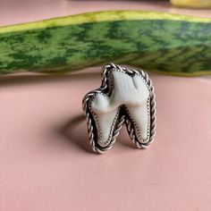 This ring is handmade, made to order using 100 percent sterling silver. It will ship within three weeks of order date. Each ring will vary slightly, due to the fact that real teeth are natural items and no two are alike. The ring pictured is very close to what the final product will be. Each ring will feature the large back side molar from a coyote. Please choose your own custom ring size! Since each ring is made to order for your exact size, we do not accept returns. Questions or comments? Plea Unique White Rings, Hand Cast White Sterling Silver Jewelry, Unique White Sterling Silver Rings, Artisan White Sterling Silver Ring, Tooth Ring Jewelry, Handmade Sterling Silver Jewelry In Bone Color, Unique Bone Colored Sterling Silver Jewelry, Cowboy Ring, Nature-inspired White Sterling Silver Rings