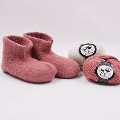 three balls of yarn and two pink slippers