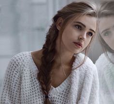 two young women with braids standing next to each other