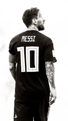 a man with tattoos on his arm and chest wearing a soccer jersey that reads messi 10