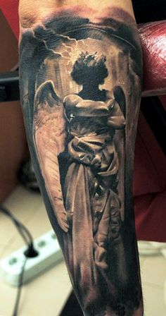 an angel tattoo on the arm