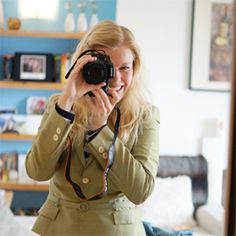 a woman taking a selfie in front of a mirror with a camera on her head