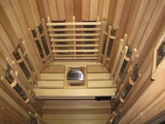 the inside of a wooden sauna with multiple compartments