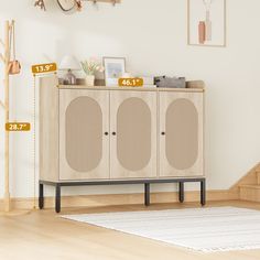 an entertainment center with measurements for the speakers on each side, and a white rug in front of it