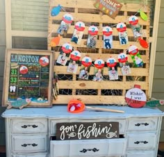 an old dresser is decorated with magnets and paper decorations for the fourth of july