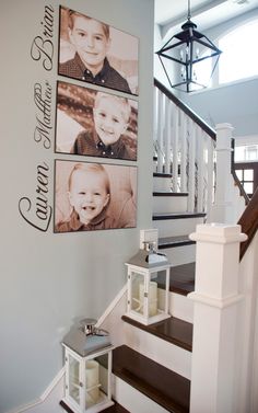 a staircase with pictures on the wall above it