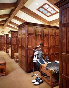 a room filled with lots of wooden closets and shoes on top of each other