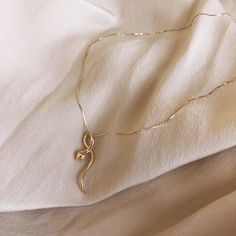 14k gold snake pendant necklace set on silk blouse Gold Snake Jewelry Necklaces, Minimalist Gold Snake Necklace, Unique Gold Snake Necklace, Gold Snake-shaped Engraved Necklace, Medusa Snake, Gold Snake-shaped Metal Necklace, Snake Pendant, Gold Chain With Pendant, Snake Necklace