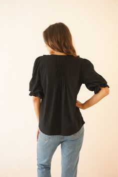 Discover our Chloe Shirt. Ethically made from a sustainable soft cotton clip dot fabric, she exudes comfort and style. Designed as a voluminous blouse, she features timeless, feminine details such as a ruffle neckline, real shell buttons, and petit pin-tucks. A true closet staple, the Chloe Shirt can be styled from day to night all year long. Responsibly Handcrafted by women artisans using high-quality sustainable fabrics certified Oeko Tex Standard 100.1% of your order funds regenerative carbon Soft Feminine Style, Feminine Details, Dot Fabric, Eco Friendly Clothing, Closet Staples, Shell Buttons, Dotted Fabric, Different Outfits, Women Artisans