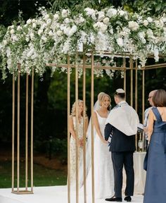 a bride and groom standing at the alter during their wedding ceremony