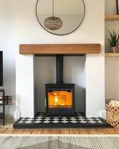 a wood burning stove in a living room with black and white checkered flooring