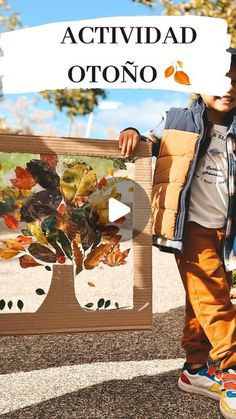 a young boy holding up a painting with leaves on it and the words activdad otno in front of him