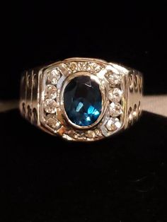 This is an OUTSTANDING RING, really beautiful, classic yet still unique It has a 10x8mm oval London Blue Topaz, surrounded by a halo of round White Topaz stones (total of 12) All natural gemstones❤ Check out the very cool SCREWHEAD accents on both sides of the band👍 Measures 15mm at widest point in front, narrows to 5.5mm in back Set in solid Sterling Silver, the ring weighs 8.1 grams. Hallmarked 925 THAILAND (with maker's mark) Size 11, ring can be sized PS in my opinion could definitely be worn by a woman too👍 Contact me with any questions Blue Oval Signet Ring For Formal Occasions, Classic Oval Sapphire Signet Ring, Classic Sapphire Oval Signet Ring, Formal Oval Sapphire Signet Ring, Formal Sapphire Oval Signet Ring, Classic Blue Oval Cabochon Signet Ring, Classic Blue Oval Signet Ring, Blue Oval Hallmarked Signet Ring, Blue Oval Signet Ring For Promise