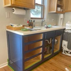 an unfinished kitchen with wooden cabinets and white counter tops