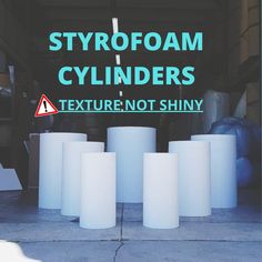 there are white cylinders sitting in front of a sign that says styrofoam cylinders texture not shiny