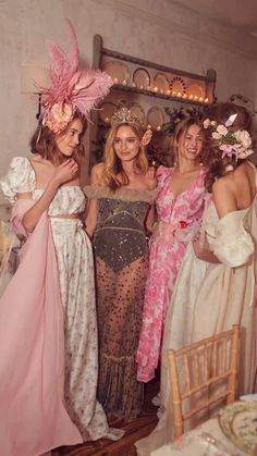 three women in dresses standing next to each other