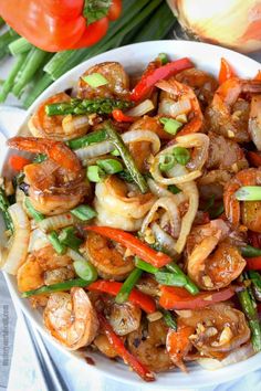 shrimp and vegetable stir fry in a white bowl