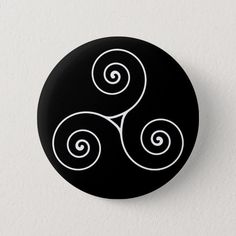 a black button with white swirls on it