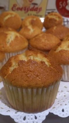 some muffins are sitting on a doily