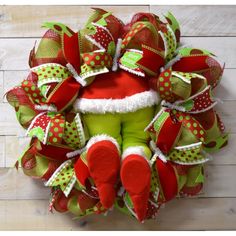 a green and red christmas wreath with santa's hat