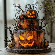 a three tiered cake decorated with carved pumpkins