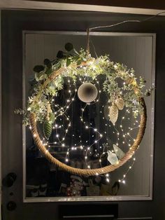 a wreath with lights hanging from it