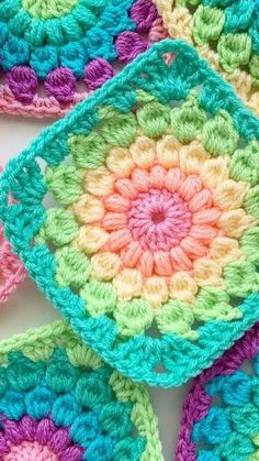 crocheted granny grannys are arranged in different colors