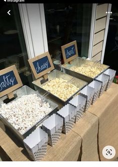 there are many different types of popcorn on the table at this wedding reception, and one is for sale