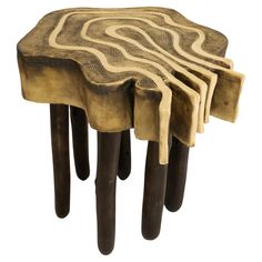 four wooden stools stacked on top of each other in the shape of a tree trunk