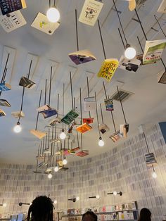 many books are hanging from the ceiling in a restaurant