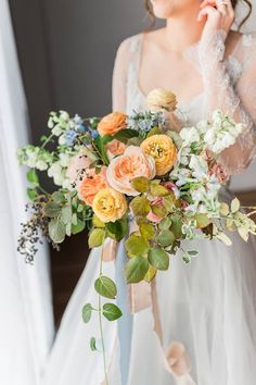 a woman holding a bouquet of flowers in her hand