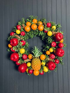 a wreath made out of fruits and vegetables