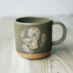 Show your love of farm animals with our original Duck mug. Ducks are good luck! They symbolize emotional connection and empathy, as well as fertility and abundance. Their molting and migration represent transformation and new beginnings. Duck Mug, Kalamazoo Michigan, Glaze Colors, Custom Gift Cards, Camping Cups, Forest Style, Emotional Connection, Wheel Thrown, Handmade Pottery