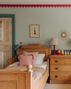 a bedroom with blue walls and wooden furniture