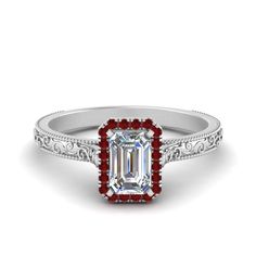 an emerald cut diamond ring with red accents