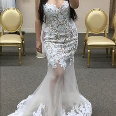 a woman taking a selfie in a wedding dress with her hand up to her face