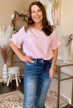 The Candy Stripe Blouse is adorable! Dress it up or go casual. Either way you look and feel amazing. It has a round neck, ruffle detail sleeve, & pink and white stripe pattern. So good with jeans or wear it to work with trousers or a skirt. 55% Poly 45% Rayon 0-4 Small 5-9 Medium 10-12 Large Chic Vertical Stripes Blouse For Day Out, Chic Vertical Stripes Blouse For Spring, Chic Spring Blouse With Vertical Stripes, Casual Blouse With Vertical Stripes For Spring, Chic Vertical Stripes Top For Spring, Chic Tops With Vertical Stripes For Spring, Pink Ruffle Sleeve Blouse For Work, Spring Blouse With Vertical Stripes And Relaxed Fit, Pink Relaxed Fit Top With Vertical Stripes