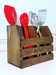 a wooden crate with utensils in it