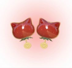 a pair of red cat shaped earrings sitting on top of each other's ears