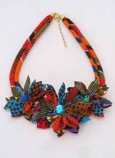 This could be an original and unique idea to give this necklace as gifts to the bridesmaid, bride etc. especially if you are organizing an unusual wedding with your personalized African touch, Boho wedding or your choice of wedding theme. It is a stunning flower necklace that I made with African wax print fabric.length of the necklace is 19 inches or 48 cm.Care: This is a fabric necklace so minimum care should be taken e.g.Do not sleep, bathe or exercise while wearing this necklace. In case of s Multicolor Unique Design Necklace As Gift, Multicolor Necklace With Unique Design For Gift, Multicolor Necklace With Unique Design As Gift, Multicolor Handmade Flower Jewelry For Wedding, Multicolor Handmade Flowers Wedding Jewelry, Handmade Multicolor Flower Wedding Jewelry, Multicolor Unique Design Jewelry As Gift, Multicolor Jewelry With Unique Design As Gift, Multicolor Flower Necklace For Wedding