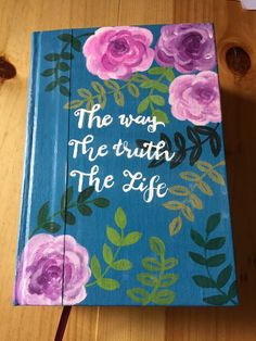 a book with flowers painted on it and the words'the way, the truth, the life '