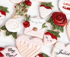 decorated cookies with roses and letters on them for valentine's day or other special occasion