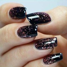 a woman's hand with black and pink glitter nail polishes on her nails