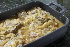 a casserole dish with meat and noodles in it