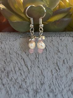 Handmade earrings made with pink beads, petal charms, and silver hardware. Smaller drop earring, about an inch in length. Handmade Pink Teardrop Flower Earrings, Pink Dangle Flower Earrings Nickel Free, Handmade Pearl Dangle Flower Earrings, Nickel-free Pink Dangle Flower Earrings, Pink Teardrop Flower Earrings With Ear Wire, Pink Sterling Silver Pearl Earrings For Pierced Ears, Pink Sterling Silver Dangle Flower Earrings, Pink Sterling Silver Drop Pearl Earrings, Nickel Free Pink Dangle Beaded Earrings