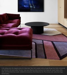 a living room filled with furniture and a painting on the wall