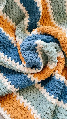 a crocheted blanket laying on top of a bed