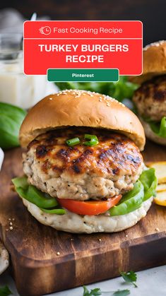 a turkey burger with lettuce and tomatoes on a cutting board