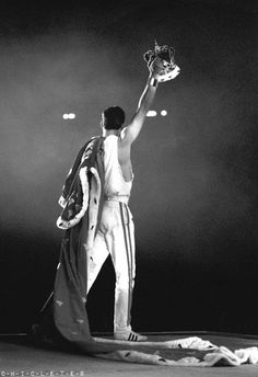 a black and white photo of a man with a baseball glove in his hand on stage