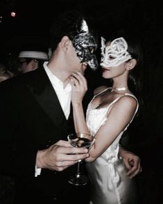 black and white photograph of a man kissing a woman with a mask on her face